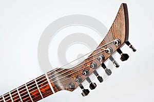 Seven-string electric guitar made of dark wood. Shot on a white background. Background for music and creativity