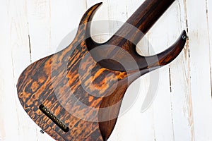 Seven-string electric guitar made of dark wood. Shot on a white background. Background for music and creativity