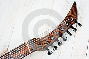 Seven-string electric guitar made of dark wood. Shot on a white background. Background for music and creativity