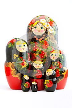 Seven traditional Russian matryoshka dolls on white background