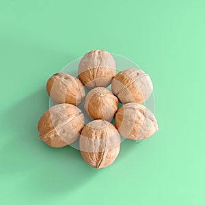 Seven walnuts on a green background