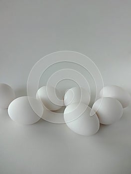 Seven White Eggs against a White Background