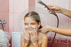 Seven-year girl bathe in a bath under shower