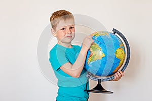 Seven-year-old boy holds globe