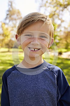 Seven year old Caucasian boy in a park, vertical portrait