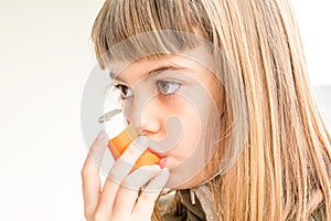 Seven year old girl breathing asthmatic medicine healthcare inhaler photo