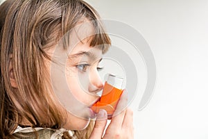 Seven year old girl breathing asthmatic medicine healthcare inhaler photo