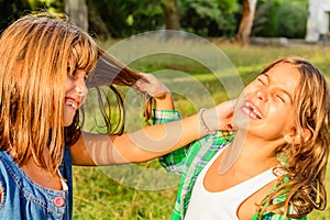 Seven year old pooling her friends hair