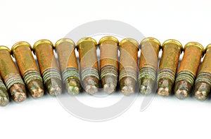 Several . 22 caliber rifle rounds, on white