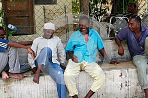 Several African men have a rest in the shade.