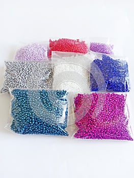 several bags of multi-colored beads in a cellophane package