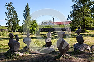 Several balanced pyramids from pebbles standing in urban park. Priozersk, Russia