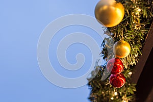 Several baubles on a stand on a Christmas market with copy space