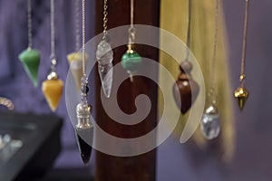 Several Beautiful Crystal Pendulums Hanging on Display