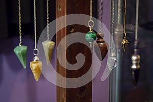 Several Beautiful Crystal Pendulums Hanging on Display