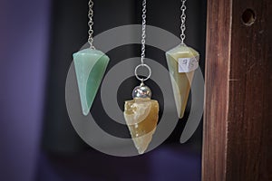 Several Beautiful Crystal Pendulums Hanging on Display