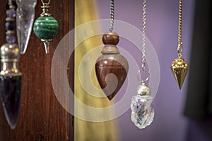 Several Beautiful Crystal Pendulums Hanging on Display