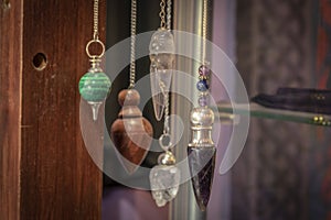 Several Beautiful Crystal Pendulums Hanging on Display