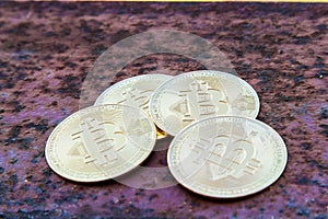 Several bitcoin Coins on rusty iron close up - image