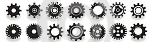 Several black gears casting shadows on a white backdrop