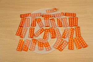 SEveral blister packs with pill capsules appearing along with euro banknotes on a tables