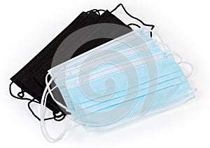 Several blue disposable medical masks and black protective face masks