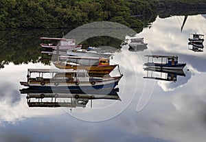 Several boats moored. Reflection of the sky in the sea.