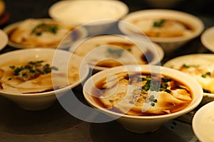 Several bowls of Chinese bean curd jelly douhua