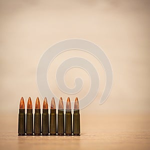 Several bullets on a wooden background