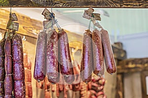 Several bunches of smoked sausage in grocery store window