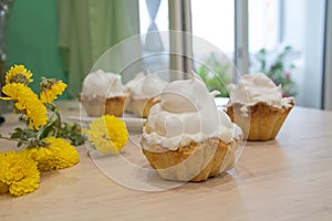 Several cakes basket with whipped cream.