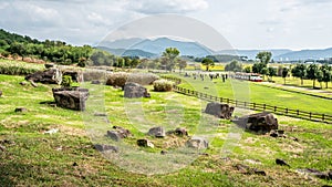 Several capstone dolmens scenery and tourists in the distance Gochang dolmens site South Korea