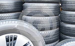 Several car tires are lined up in a tire shop