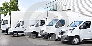 Several cars vans trucks parked in parking lot for rent