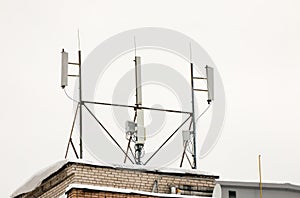 Several cellular antennas on the roof of the house provide communication.