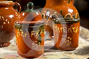 Several ceramics jars for containing saffron and pepper (words written in spanish)