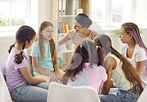 Several children having a discussion in group therapy with their school psychologist