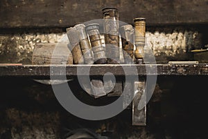 Several chisels hanging on wooden plank
