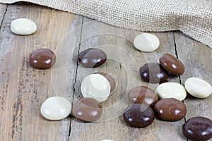 Several chocolate kruidnoten on wooden surface