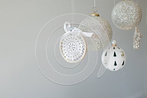 Several Christmas ornaments hanging on a white background