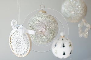 Several Christmas ornaments hanging on a white background