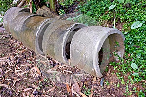 Several circular concrete culverts, on the side of the road, with a natural soil background photo