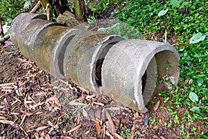 Several circular concrete culverts, on the side of the road, with a natural soil background photo