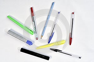 Several colored pens used in schools and offices isolated with space for text photo