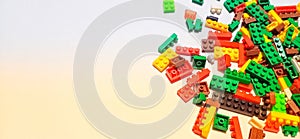 several colorful lego blocks on a gradient yellow background