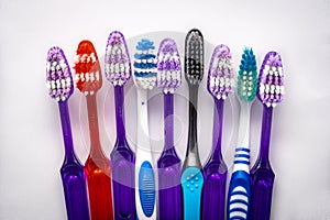 Several colorful toothbrushes stacked up together