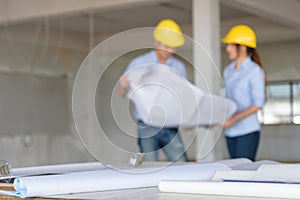 Several of construction design tools with Abstract blurred engineers reading blueprint and discuss about construction project