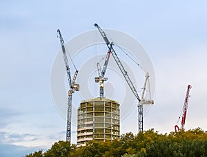 Several cranes on constructions sites at high buildings all over London UK