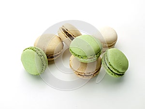 Several cream and green macarons with chocolate scratches photo
