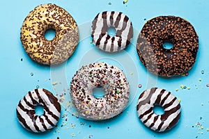 Several different donuts on blue background